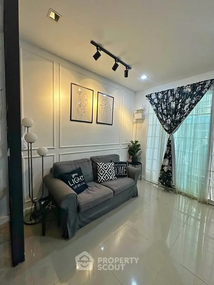 Stylish living room with modern decor, cozy sofa, and elegant lighting, perfect for relaxation and entertaining.