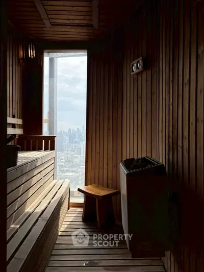 Luxurious sauna with stunning city view, featuring wooden interiors and modern amenities for ultimate relaxation.