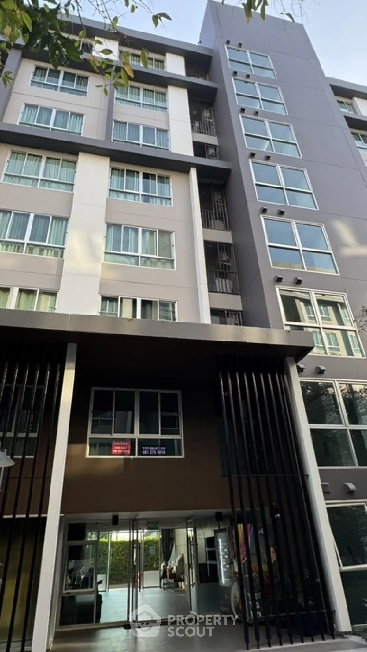 Modern apartment building exterior with large windows and sleek design