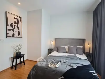 Modern bedroom with stylish decor and cozy ambiance, featuring elegant lighting and contemporary artwork.