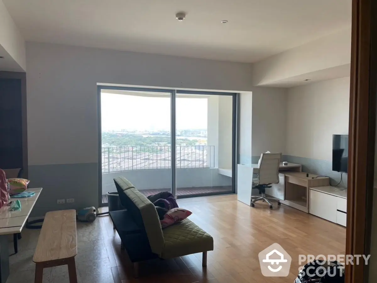 Spacious living room with balcony and city view, modern furniture and natural light