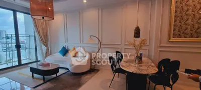 Elegant living room with modern decor and city view, featuring a cozy sofa and stylish dining area.