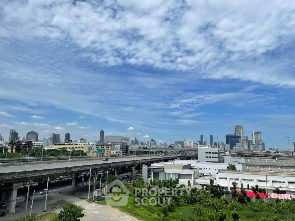 Stunning cityscape view with highways and skyscrapers under a clear blue sky.