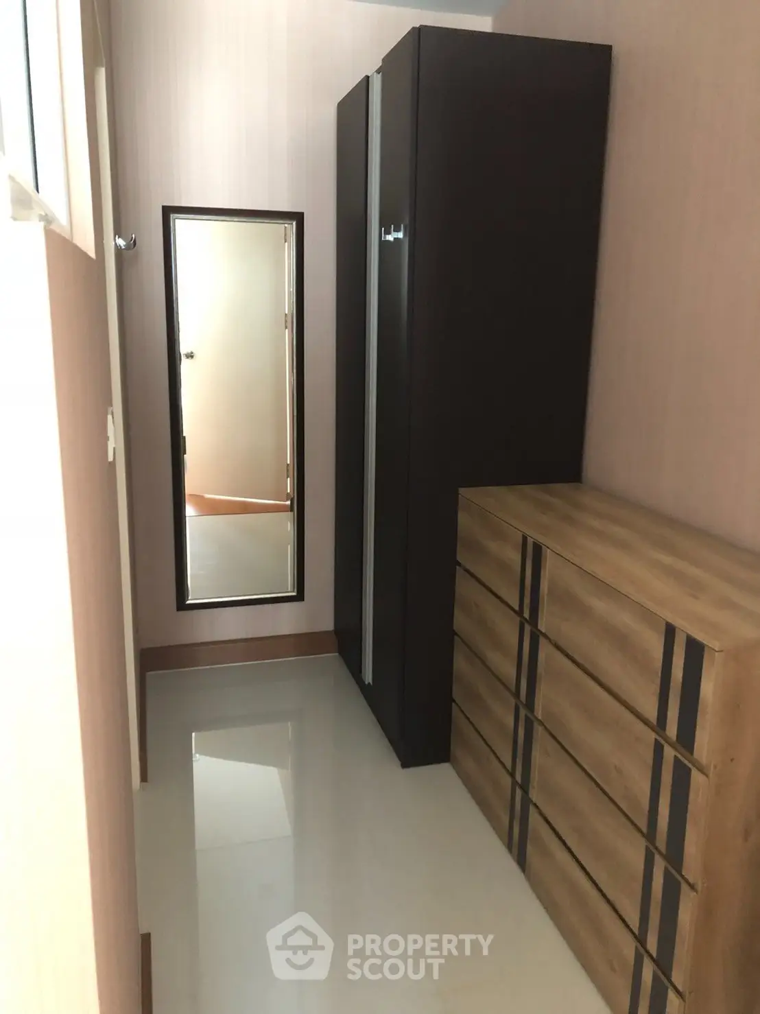 Compact storage area with sleek wardrobe and dresser in modern apartment