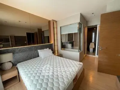 Modern bedroom with ensuite bathroom featuring sleek design and cozy ambiance.