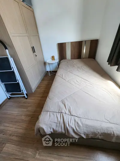 Cozy bedroom with wooden flooring and modern furniture