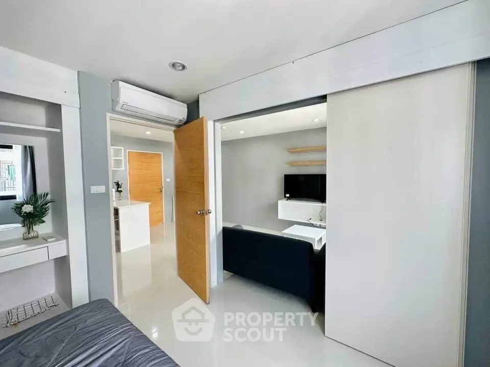 Modern apartment interior with sleek design and open layout, featuring a cozy living area and stylish decor.