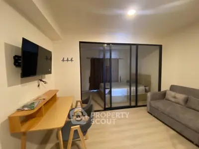 Modern living room with glass partition and cozy furniture