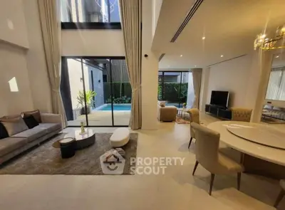 Luxurious open living room with pool view and elegant decor