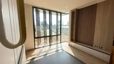 Modern living room with large windows and stylish wood paneling