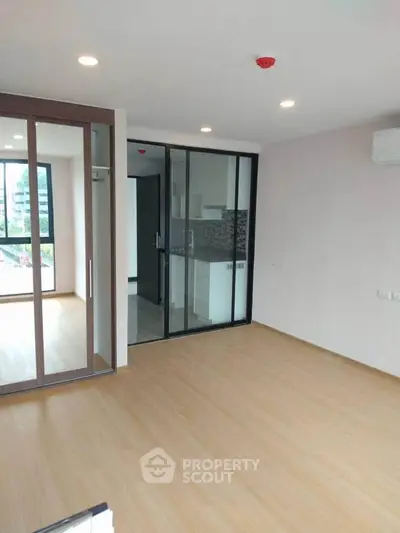 Modern apartment interior with glass partition and wooden flooring