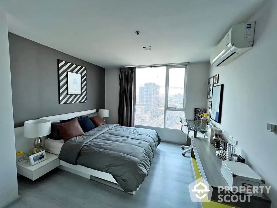 Modern bedroom with city view, stylish decor, and ample natural light.