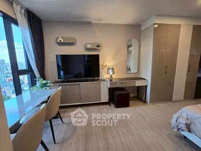 Modern bedroom with city view, sleek furniture, and natural light