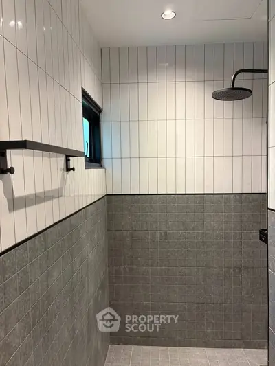 Modern bathroom with sleek tile design and rainfall showerhead