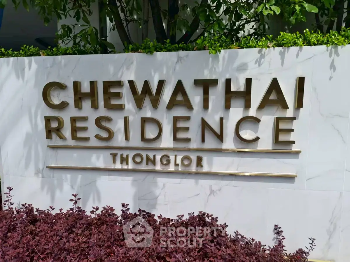 Chewathai Residence Thonglor entrance sign with lush greenery
