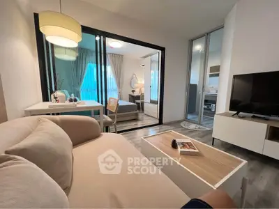 Modern living room with cozy sofa and stylish decor leading to a bright bedroom.