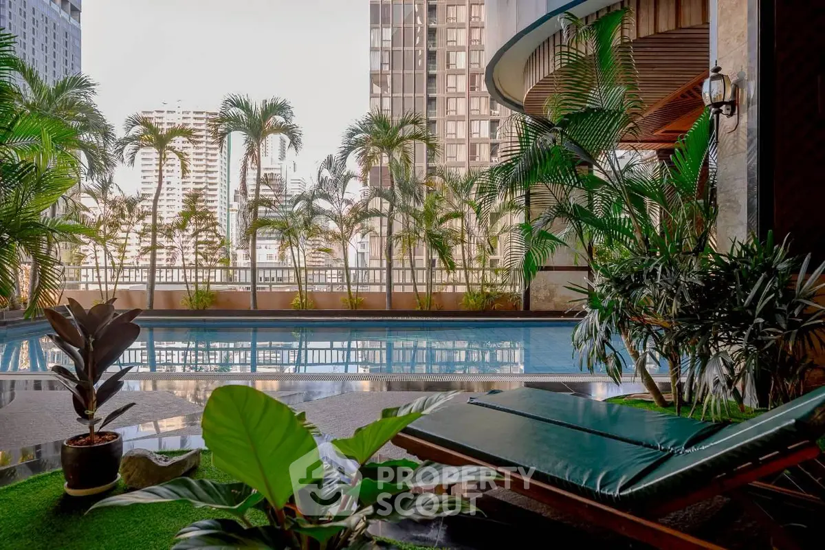 Luxurious urban pool area with lush greenery and city skyline views, perfect for relaxation and leisure.