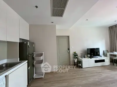 Modern open-plan living room with sleek kitchen and stylish decor