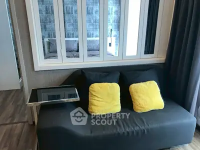 Modern living room with stylish sofa and vibrant yellow cushions