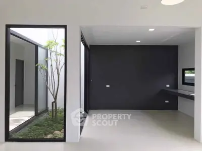 Modern minimalist interior with large windows and sleek design, perfect for natural light and open space.