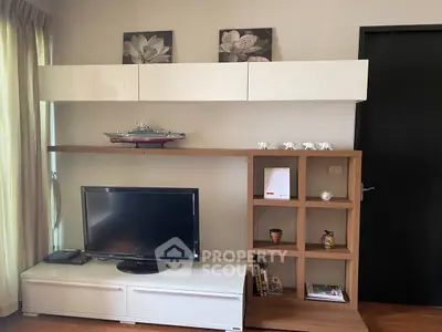 Modern living room with sleek TV unit and decorative shelves, perfect for stylish urban living.