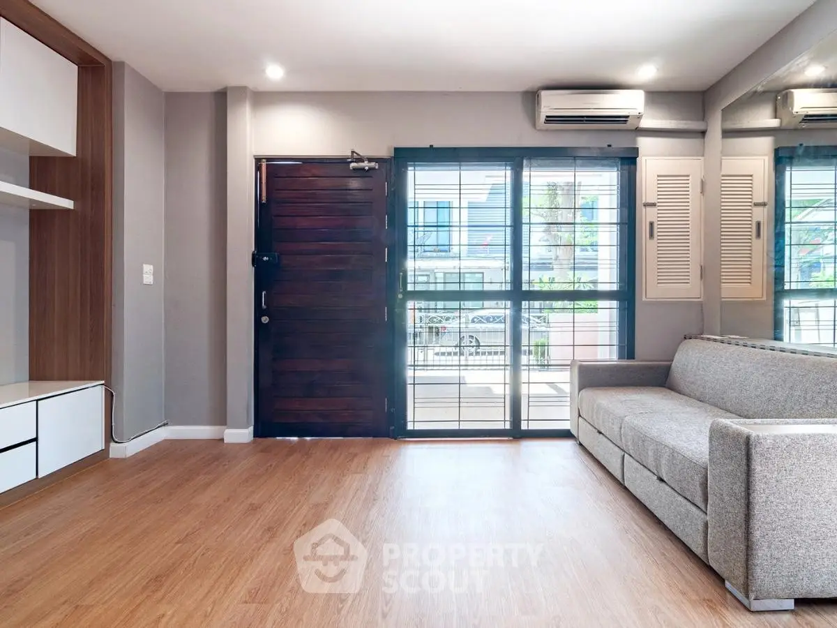 Spacious living room with modern decor and large windows for natural light.
