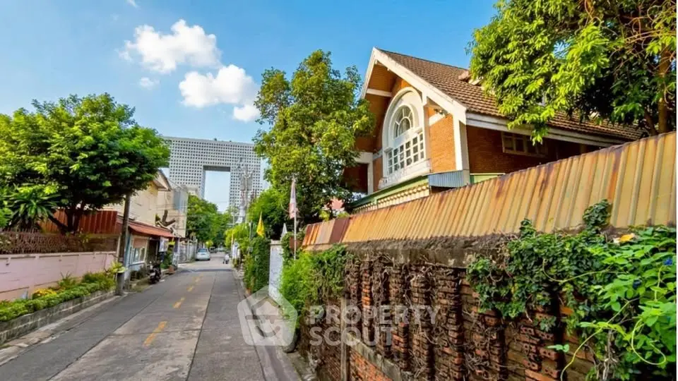 Charming suburban street with lush greenery and unique architectural homes.