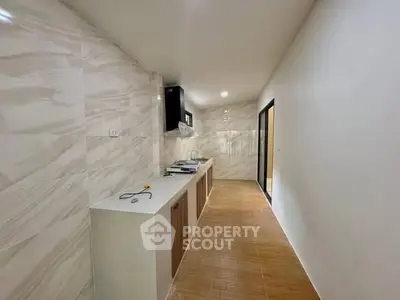 Modern kitchen with sleek design and ample counter space in a stylish home.