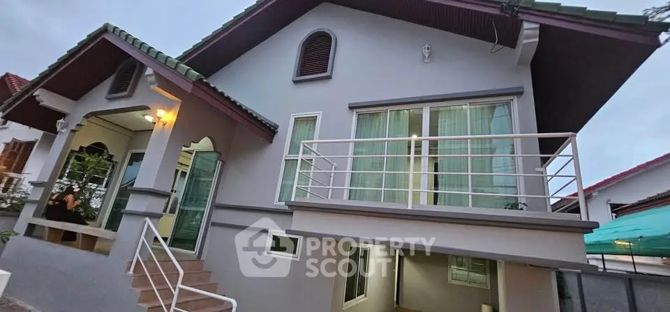 Charming two-story house with modern design and spacious balcony, perfect for family living.