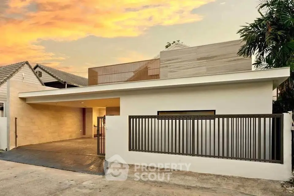 Modern architectural home exterior with sleek design and sunset backdrop