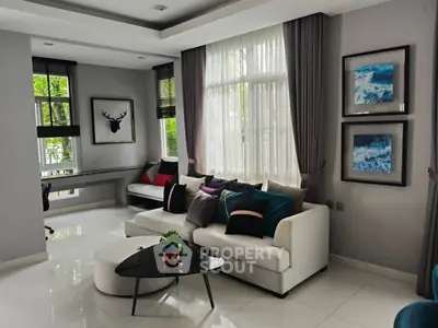 Stylish modern living room with elegant decor and large windows for natural light.