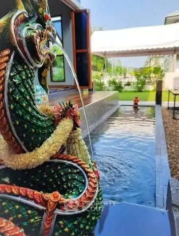 Stunning garden with decorative water feature and serene pond, perfect for relaxation.