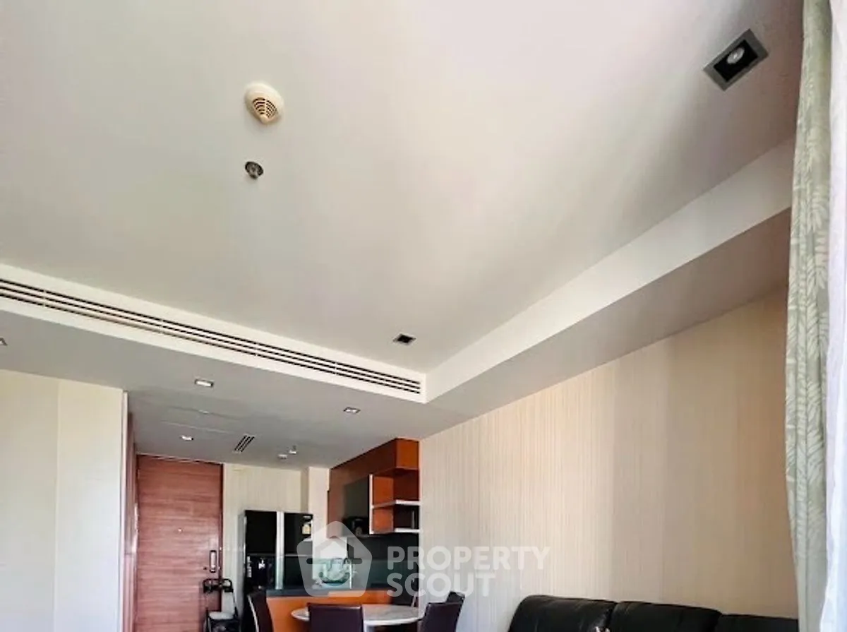 Modern living room with open kitchen layout and stylish furniture