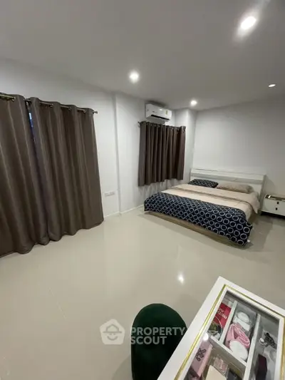 Spacious bedroom with modern decor and ample natural light