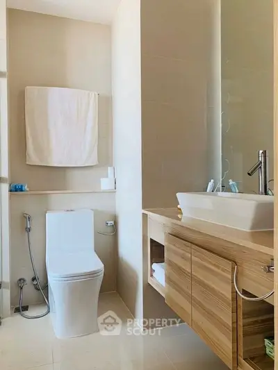 Modern bathroom with sleek fixtures and wooden cabinetry