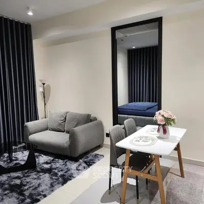 Modern living room with cozy sofa, dining table, and elegant decor in a stylish apartment.