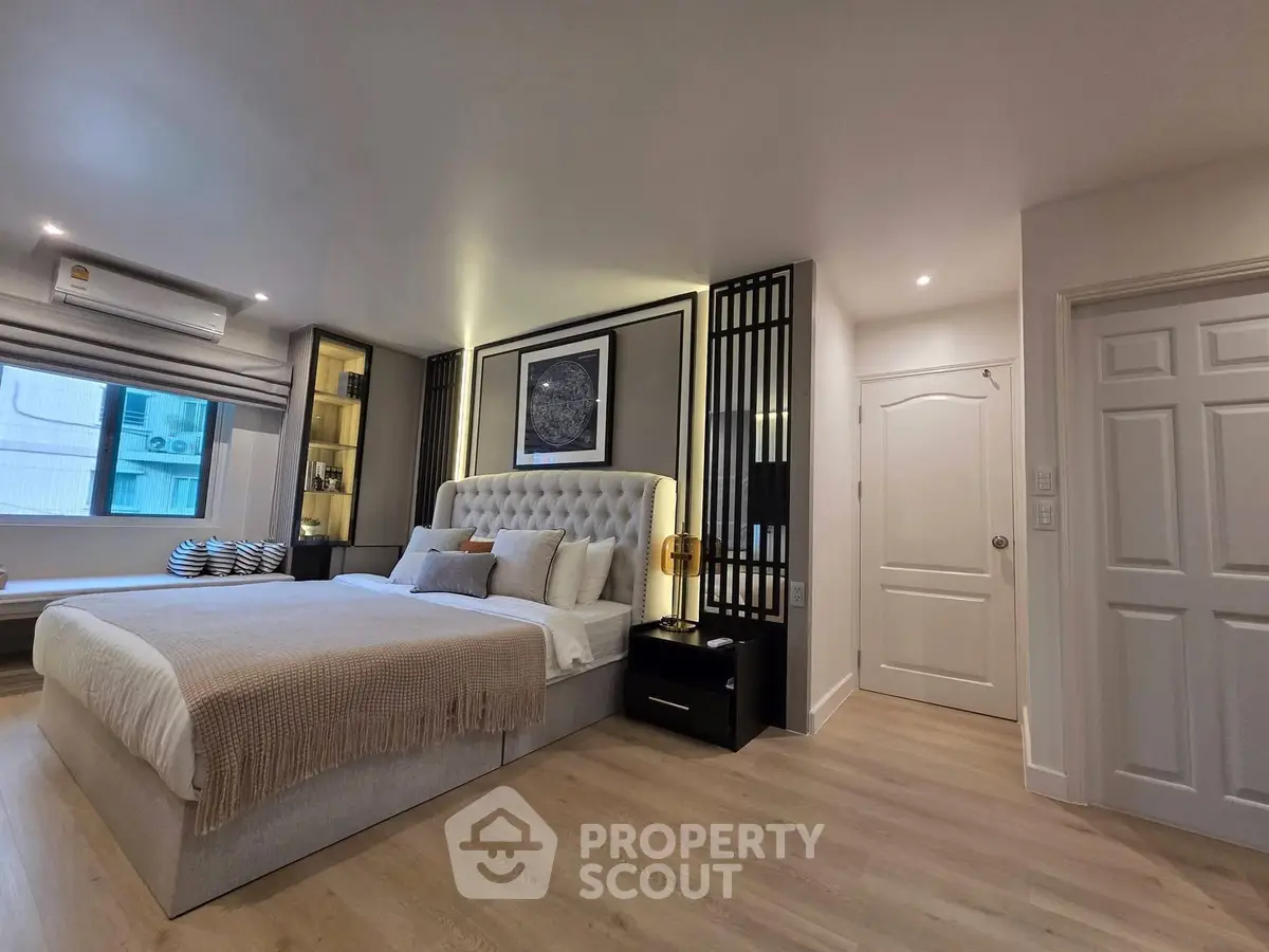 Luxurious modern bedroom with elegant decor and ambient lighting, featuring a plush bed and stylish furnishings.