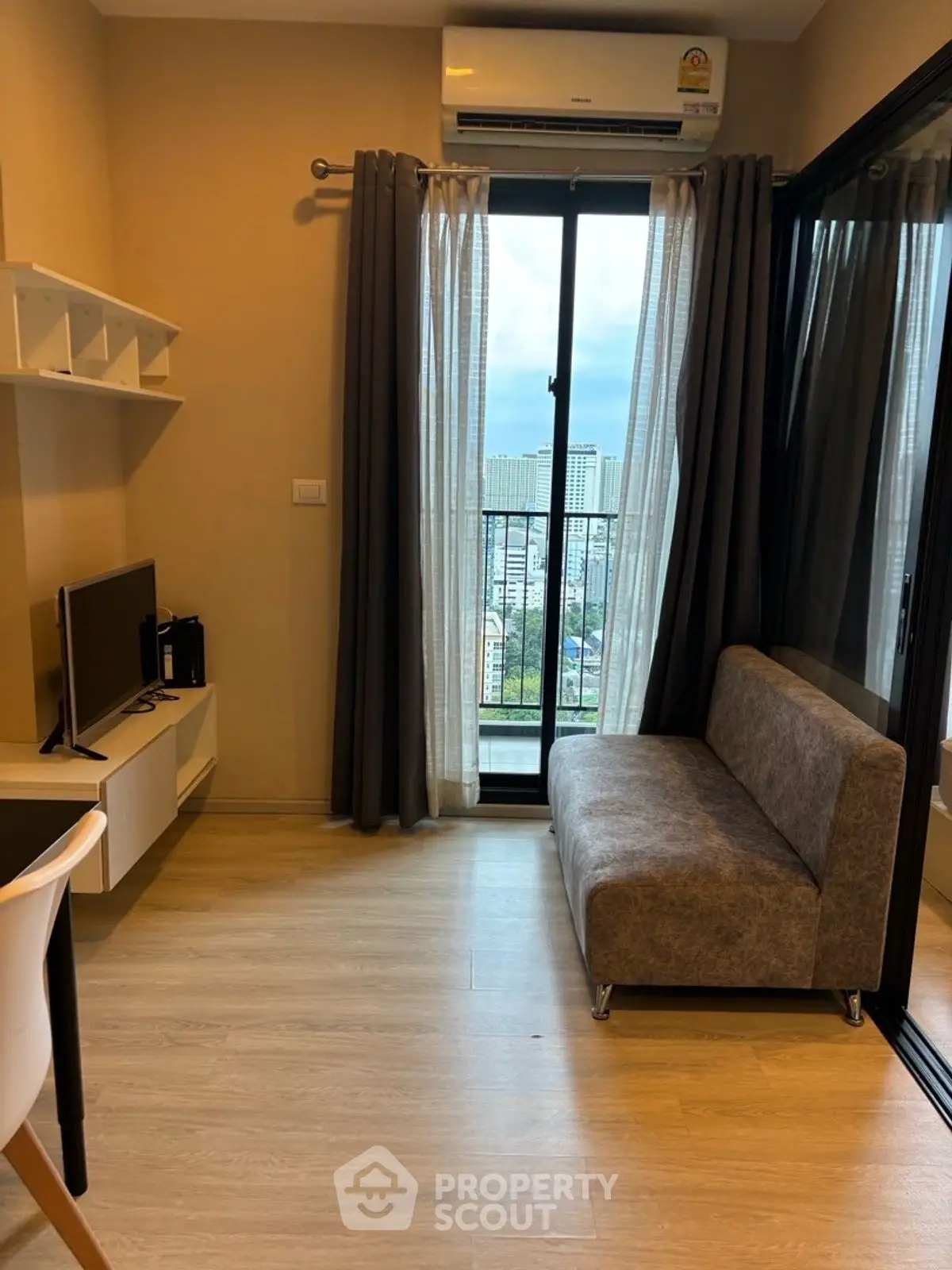 Modern living room with balcony view in high-rise apartment