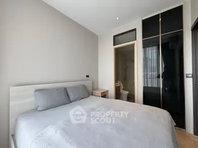 Modern bedroom with ensuite bathroom and sleek wardrobe design