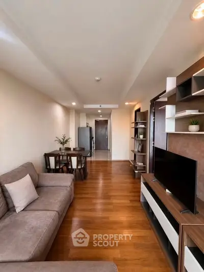 Spacious modern living room with elegant wooden flooring and stylish furniture