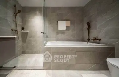 Luxurious modern bathroom with elegant marble tiles and spacious bathtub.
