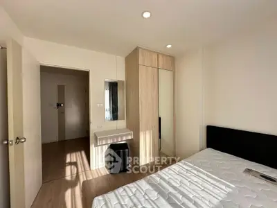Modern bedroom with sleek wardrobe and natural light in a stylish apartment.
