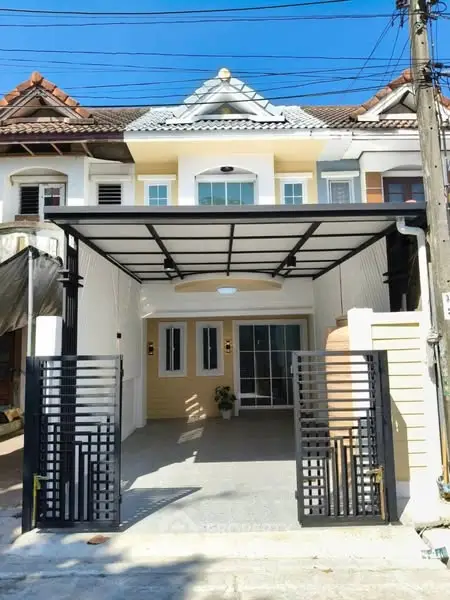 Charming townhouse with modern facade and spacious driveway in a serene neighborhood.