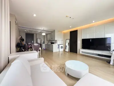 Spacious modern living room with open kitchen and sleek furnishings