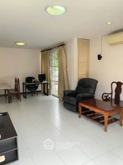 Spacious living room with elegant furniture and natural light, perfect for relaxation and entertainment.