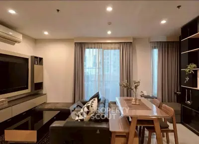 Modern living room with stylish furniture and large windows