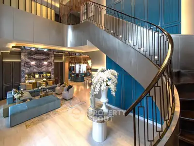 Luxurious living room with elegant staircase and modern decor