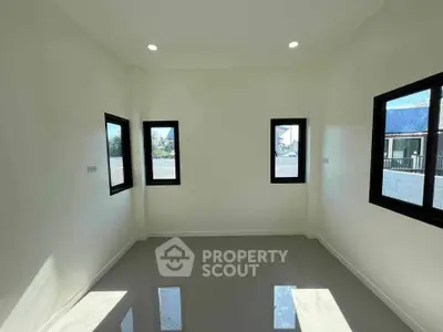 Bright empty room with large windows and glossy tiled floor