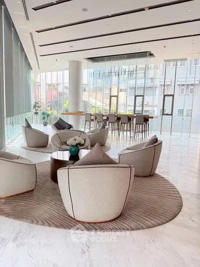 Luxurious modern lobby with elegant seating and floor-to-ceiling windows offering city views.
