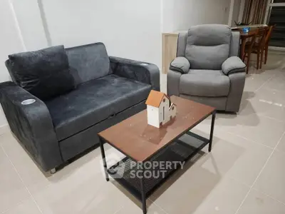 Modern living room with stylish furniture and sleek coffee table in a cozy setting.